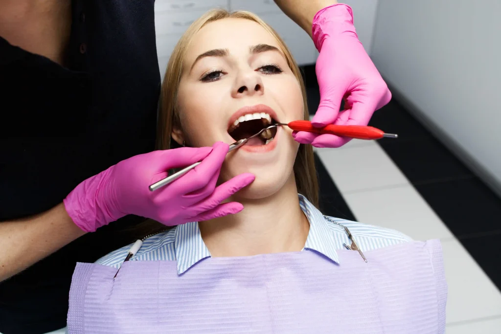 Dentist examining teeth before deep cleaning teeth procedure