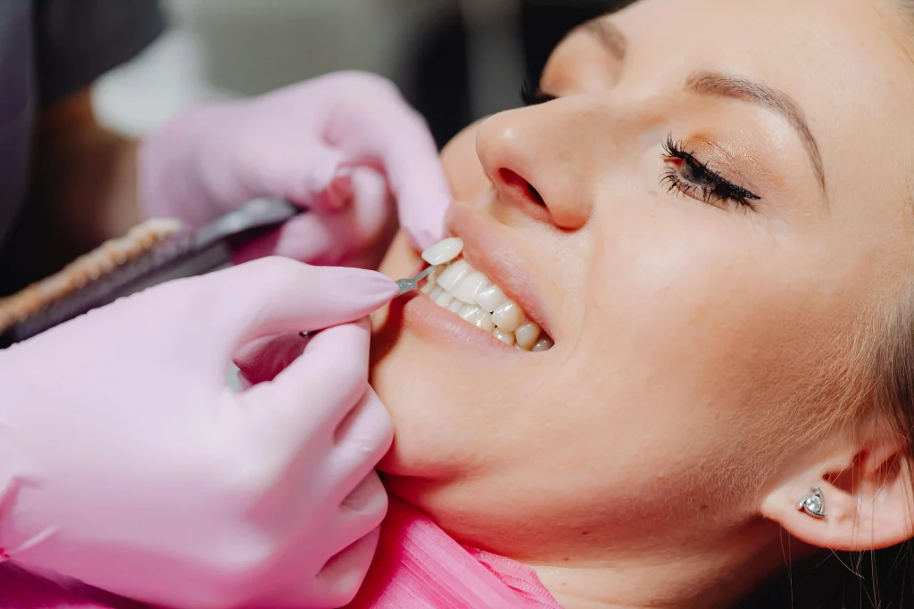 Dentist examining a patient whose tooth is loose but still attached during a dental checkup to assess tooth stability and oral health.