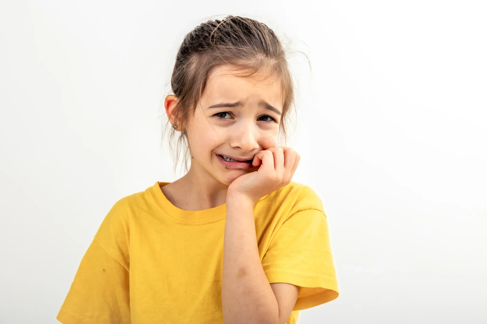 scared anxious girl biting her fingernails white background isolated 1